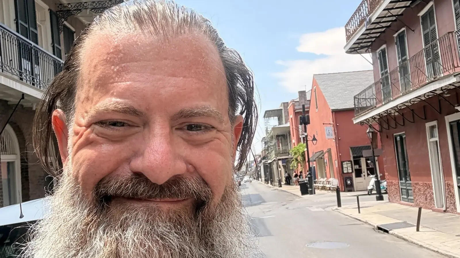 Loren Weisman, brand communications and optics strategist, smiling on a French Quarter street in New Orleans.
